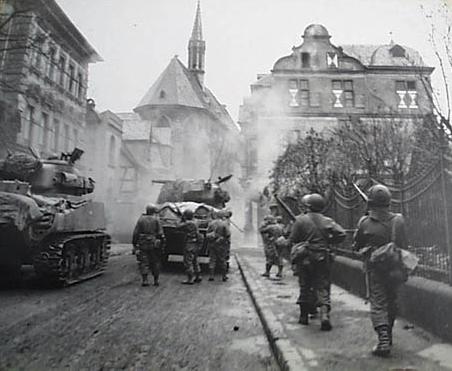 63 Armored infantry Battalion troops and tanks attacking sniper positions, Andernach Germany, March 9 1945.