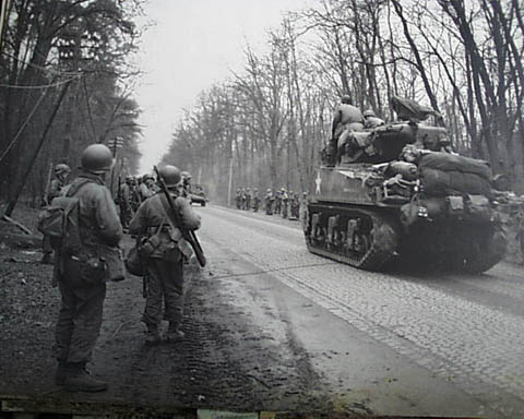 Passing troops of the 26th Inf Div, Langenselbold Germany, March 30 1945.