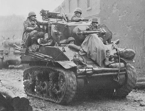 F3AD Stuart Light Tank with a wounded German prisoner (under blanket).