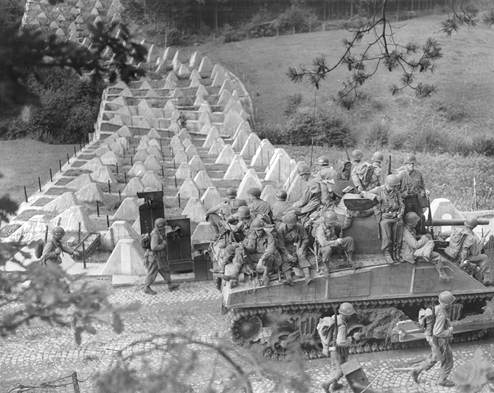 3AD Tank & Troops passing through the Siegfried Line.