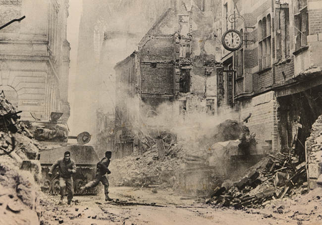 3rd Armored Division tankers under fire, Cologne Germany, March 6. 1945.
