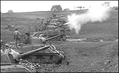 Shermans bombard German positions.